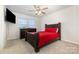 This bedroom features neutral carpet and a bed with windows providing natural light at 5043 Baileys Run Dr, Rock Hill, SC 29732