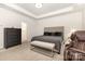 Bright main bedroom featuring a tray ceiling, gray color palette, and a seating area bench at 5043 Baileys Run Dr, Rock Hill, SC 29732