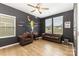 Room featuring hardwood floors, an accent wall, a ceiling fan, and a leather sofa at 5043 Baileys Run Dr, Rock Hill, SC 29732