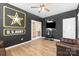 Room featuring hardwood floors, an accent wall, a ceiling fan, and a TV at 5043 Baileys Run Dr, Rock Hill, SC 29732