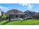 Expansive backyard featuring a spa, bar area, and modern solar panels for energy efficiency at 5050 Havencrest Dr, Fort Mill, SC 29715