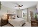Cozy bedroom with wood furnishings, a ceiling fan, and natural light from a window with neighborhood views at 5050 Havencrest Dr, Fort Mill, SC 29715