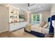 Beautiful bedroom with built-ins, tray ceiling and a window view creating a serene retreat at 5050 Havencrest Dr, Fort Mill, SC 29715