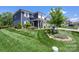Beautiful home with lush green lawn and landscaped garden; view from the corner of the lot at 5050 Havencrest Dr, Fort Mill, SC 29715