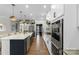 Bright, open kitchen featuring an island, stainless steel appliances, and custom white cabinets at 5050 Havencrest Dr, Fort Mill, SC 29715