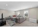 Spacious living room with large sectional sofa, neutral walls, and natural light, great for relaxation and entertaining at 5050 Havencrest Dr, Fort Mill, SC 29715