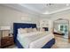 Bright main bedroom with a large bed, hardwood floors and an ensuite bathroom at 5050 Havencrest Dr, Fort Mill, SC 29715