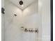 This modern shower with neutral tile also has a small built in plant shelf and wall mounted soap dispensers at 5050 Havencrest Dr, Fort Mill, SC 29715