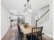 Open dining area featuring a wooden table, modern lighting, and easy access to the adjacent kitchen and staircase at 507 Newsome Rd, Salisbury, NC 28146