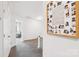 Hallway upstairs with a framed collage on the wall and a view of an adjacent living area with soft armchairs at 507 Newsome Rd, Salisbury, NC 28146