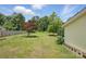 Backyard with a well-maintained lawn, privacy fence, and a view of the home's exterior at 522 Alexander St, Statesville, NC 28677