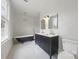 Bright bathroom featuring a black clawfoot tub, black and white mosaic tile floor and double sink vanity at 522 Alexander St, Statesville, NC 28677