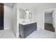 This bathroom features a black and white tiled floor, with a dual sink vanity and gold fixtures at 522 Alexander St, Statesville, NC 28677