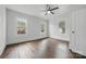 Bedroom featuring hardwood floors, three windows providing natural light and a ceiling fan at 522 Alexander St, Statesville, NC 28677