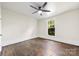 Empty bedroom featuring wood floors, neutral walls, a ceiling fan and a window showcasing natural light at 522 Alexander St, Statesville, NC 28677