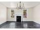 Bright dining room featuring a modern chandelier, fireplace, and large windows, showcasing the home's potential at 522 Alexander St, Statesville, NC 28677