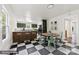 Open kitchen with black-and-white floors, island seating, and a breakfast nook with table at 522 Alexander St, Statesville, NC 28677