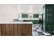 View of a vibrant kitchen featuring retro green cabinetry, black appliances, and a checkered floor at 522 Alexander St, Statesville, NC 28677