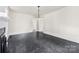 Bright, open living room featuring a modern light fixture and sleek, dark marble-patterned flooring at 522 Alexander St, Statesville, NC 28677