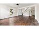 Bright living room showcasing hardwood floors, large windows, and a staircase to the upper level at 522 Alexander St, Statesville, NC 28677