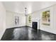 Bright living room featuring a fireplace, windows, and stylish dark flooring at 522 Alexander St, Statesville, NC 28677