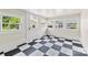Bright and airy room with multiple windows and black and white checkered flooring at 522 Alexander St, Statesville, NC 28677
