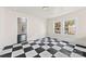 Room filled with natural light, enhanced by black and white checkered floors and neutral-toned walls at 522 Alexander St, Statesville, NC 28677