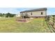 The backyard boasts a brick firepit, wooden deck, and sprawling green lawn, perfect for outdoor activities at 5333 Lake Glenn Dr, Stanfield, NC 28163