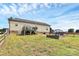 Spacious backyard with wooden deck, brick firepit, and well-maintained lawn perfect for entertaining and relaxing at 5333 Lake Glenn Dr, Stanfield, NC 28163
