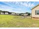 The fenced backyard features a meticulously maintained lawn, a charming firepit area, and a home with neutral siding at 5333 Lake Glenn Dr, Stanfield, NC 28163
