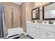 Bathroom featuring double sink vanity, tub with tiled shower, and wood-look floors at 5333 Lake Glenn Dr, Stanfield, NC 28163