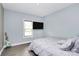 Bedroom featuring a guitar, TV, wood look floors, and a window at 5333 Lake Glenn Dr, Stanfield, NC 28163