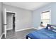 Bedroom with blue and gray accents, laminate floors, and ample natural light at 5333 Lake Glenn Dr, Stanfield, NC 28163