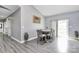 Bright dining area featuring modern gray floors, and a sliding door to the backyard at 5333 Lake Glenn Dr, Stanfield, NC 28163