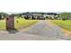 Quaint single-story home featuring a long gravel driveway and a lush front lawn at 5333 Lake Glenn Dr, Stanfield, NC 28163