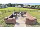 Brick patio features a firepit and wicker furniture, ideal for backyard gatherings with its cozy ambiance at 5333 Lake Glenn Dr, Stanfield, NC 28163