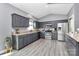 Spacious kitchen features gray cabinets, stainless appliances, and hardwood laminate flooring at 5333 Lake Glenn Dr, Stanfield, NC 28163