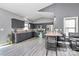 Spacious kitchen with a center island, gray cabinets, stainless steel appliances, and hardwood laminate flooring at 5333 Lake Glenn Dr, Stanfield, NC 28163