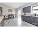 Bright kitchen with gray cabinets, laminate flooring, and dining area leading to an outdoor patio at 5333 Lake Glenn Dr, Stanfield, NC 28163