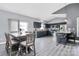 Open-concept kitchen boasts stainless steel appliances, gray cabinets, and an adjacent dining area at 5333 Lake Glenn Dr, Stanfield, NC 28163