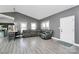 Spacious living room with sleek flooring, recessed lighting, and a comfortable gray leather sofa at 5333 Lake Glenn Dr, Stanfield, NC 28163
