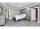 Main bedroom featuring wood look floors, tray ceiling, and neutral walls at 5333 Lake Glenn Dr, Stanfield, NC 28163