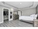 Main bedroom featuring walk-in closet, dresser and bed with decorative pillows at 5333 Lake Glenn Dr, Stanfield, NC 28163