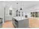 Bright kitchen boasts an oversized island with seating, built-in microwave and pendant lighting at 5615 Lantana Ave # A, Charlotte, NC 28205