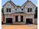 New construction home featuring a modern design with a covered front porch and attached garages at 5615 Lantana Ave # B, Charlotte, NC 28205