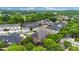Wide aerial perspective of a residential area displays various house designs, landscaped yards, and a peaceful, green environment at 6011 Nw Village Nw Dr, Concord, NC 28027