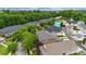 High-angle shot showcases a neighborhood with diverse home styles, manicured lawns, and dense foliage, offering privacy at 6011 Nw Village Nw Dr, Concord, NC 28027