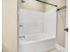 White bathtub and shower combo, complete with tile surround at 6011 Nw Village Nw Dr, Concord, NC 28027