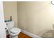 Half bath with hardwood floors, white fixtures, and a simple design at 6011 Nw Village Nw Dr, Concord, NC 28027