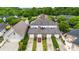 Close aerial view of a well-kept multi-Gathering home with individual driveways and landscaping, offering comfortable living at 6011 Nw Village Nw Dr, Concord, NC 28027